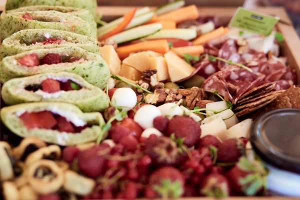 Catering box background - - set with fresh green pita with strawberries, vegetables, meat and cheese. Easy way to eat for business or party. High quality photo
